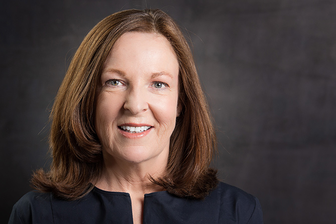 Anne Mooney, smiling woman in navy shirt