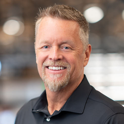 Christopher Lund, smiling man in black shirt