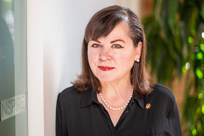 Legends: Jeanne Jackson, FAIA, NCARB, LEED AP; Person with blurred face, indoors.